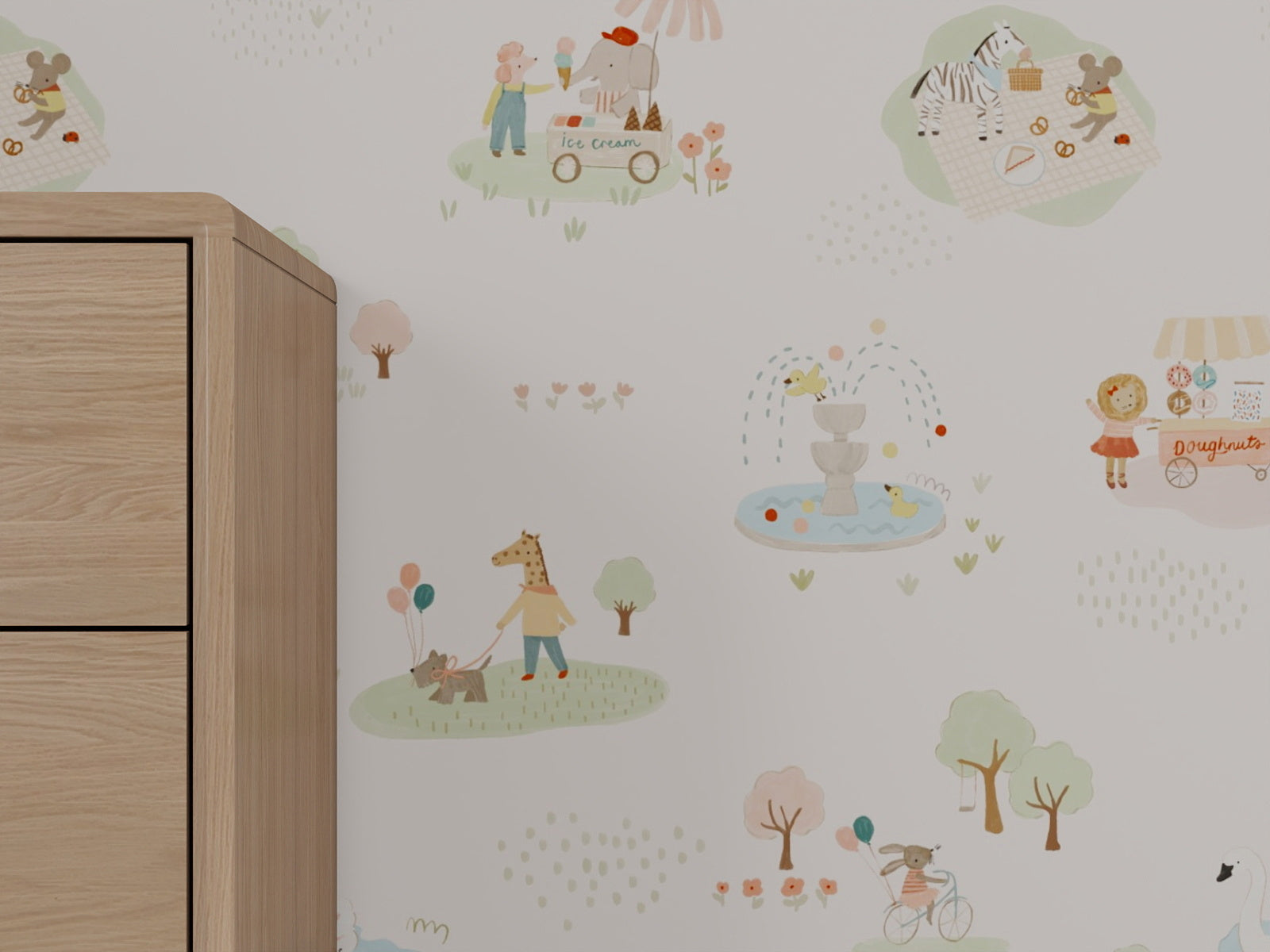 Little Friends Day Out Wallpaper features playful drawings of animals and children enjoying a picnic, walking a dog, riding bikes, playing by a fountain, and buying ice cream; a wooden cabinet appears partially on the left.