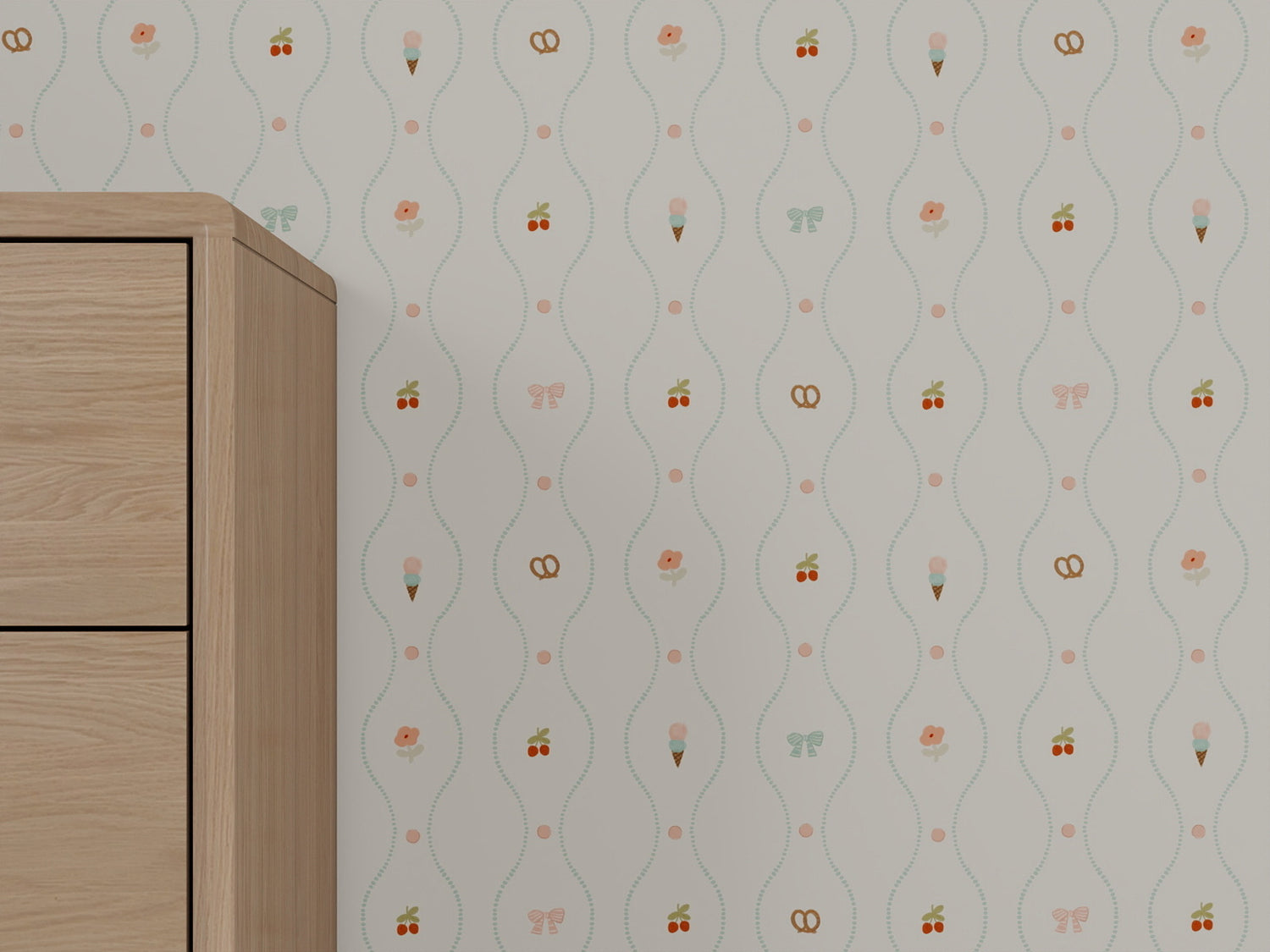 The Little Patisserie Stripe Wallpaper features a whimsical striped pattern with small icons—ice cream cones, pretzels, cherries, butterflies, and flowers—creating a light and playful touch for the nursery. A light wood dresser is partly visible on the left.