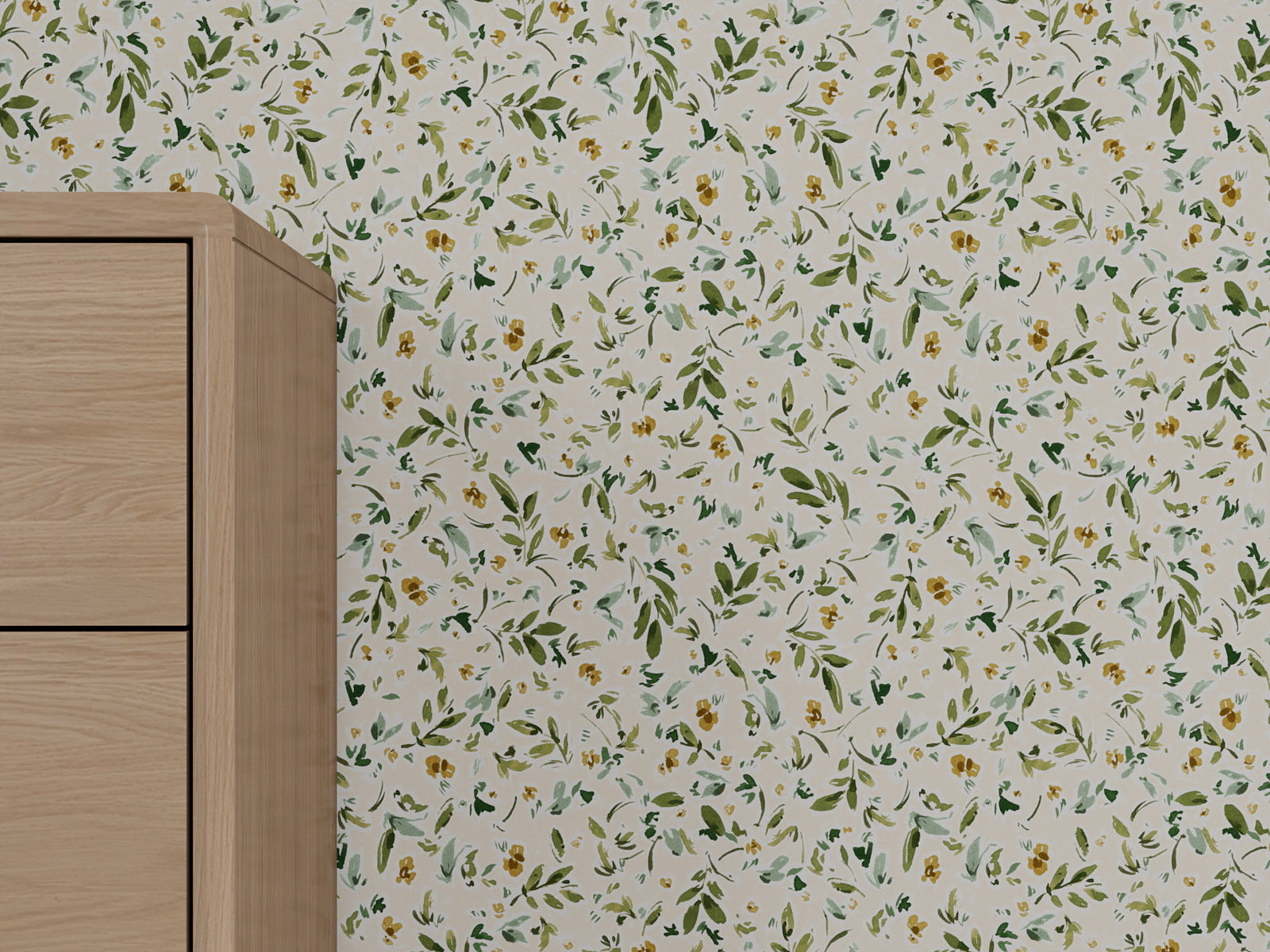 A close-up of a light wood cabinet beside a wall covered with Meadow Flutter Leaves Wallpaper in cream, featuring a green and yellow floral pattern for nature-inspired kids room decor.
