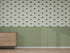 A room with light green walls, a wooden dresser on the left, and the Custom Otis Dinosaur 1 | Sample wallpaper above solid green wainscoting. The light brown wood floor perfectly complements the playful wallpaper color.