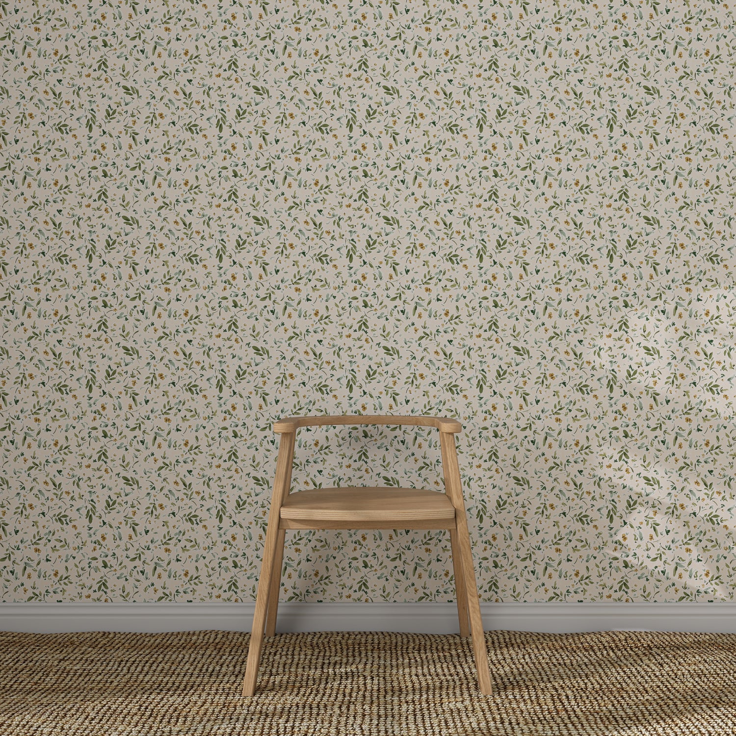 A simple wooden chair sits on a woven rug in front of a wall adorned with Meadow Flutter Leaves Wallpaper, featuring a light-colored, small-scale floral pattern with green and yellow accents.