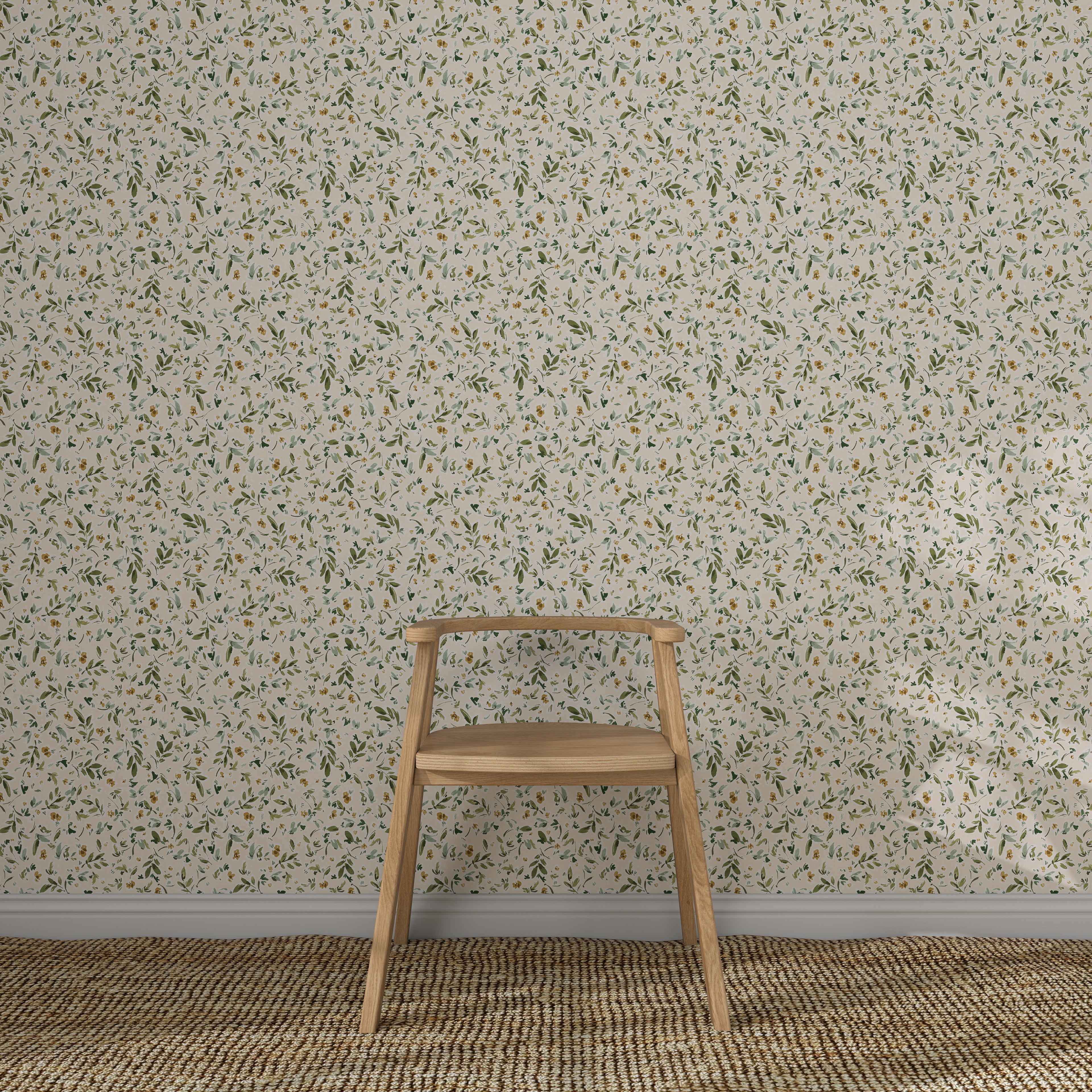 A simple wooden chair sits on a woven rug in front of a wall adorned with Meadow Flutter Leaves Wallpaper, featuring a light-colored, small-scale floral pattern with green and yellow accents.