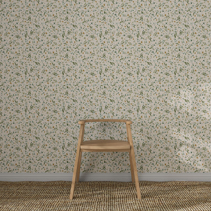 A simple wooden chair sits on a woven rug in front of a wall adorned with Meadow Flutter Leaves Wallpaper, featuring a light-colored, small-scale floral pattern with green and yellow accents.