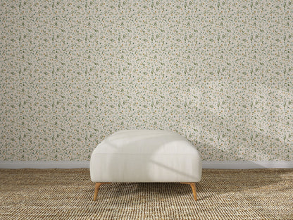 A white upholstered ottoman rests on a textured rug before a wall decorated with Meadow Flutter Leaves Wallpaper, creating a minimal, well-lit kids&