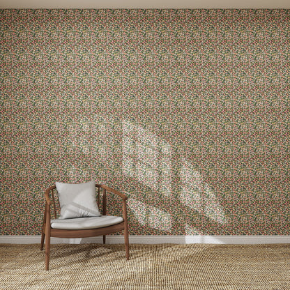 A wooden chair with a light cushion sits on a woven rug before a wall covered in Midnight Meadow Florals Wallpaper | Sample, its vibrant colors illuminated by sunlight casting window-shaped shadows across the intricate floral design.