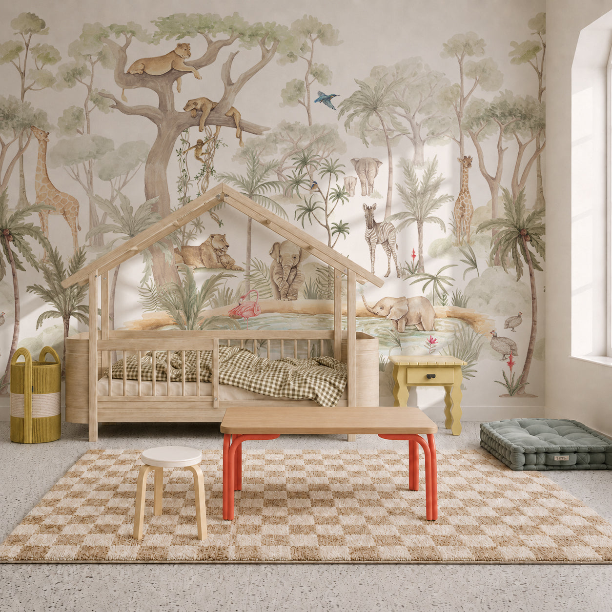 Children’s bedroom featuring a wooden house-shaped bed, the Safari Savannah Adventure Mural as nursery wallpaper, a checkered rug, a wooden table with stools, and soft green storage baskets. Natural light comes in from a tall window on the right.