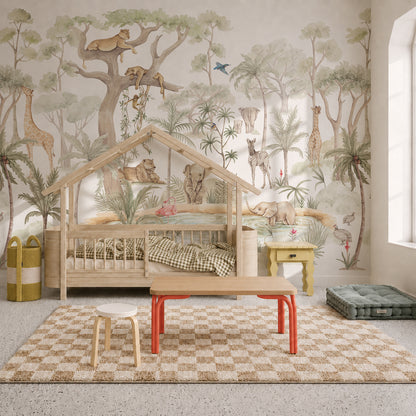 Children’s bedroom featuring a wooden house-shaped bed, the Safari Savannah Adventure Mural as nursery wallpaper, a checkered rug, a wooden table with stools, and soft green storage baskets. Natural light comes in from a tall window on the right.