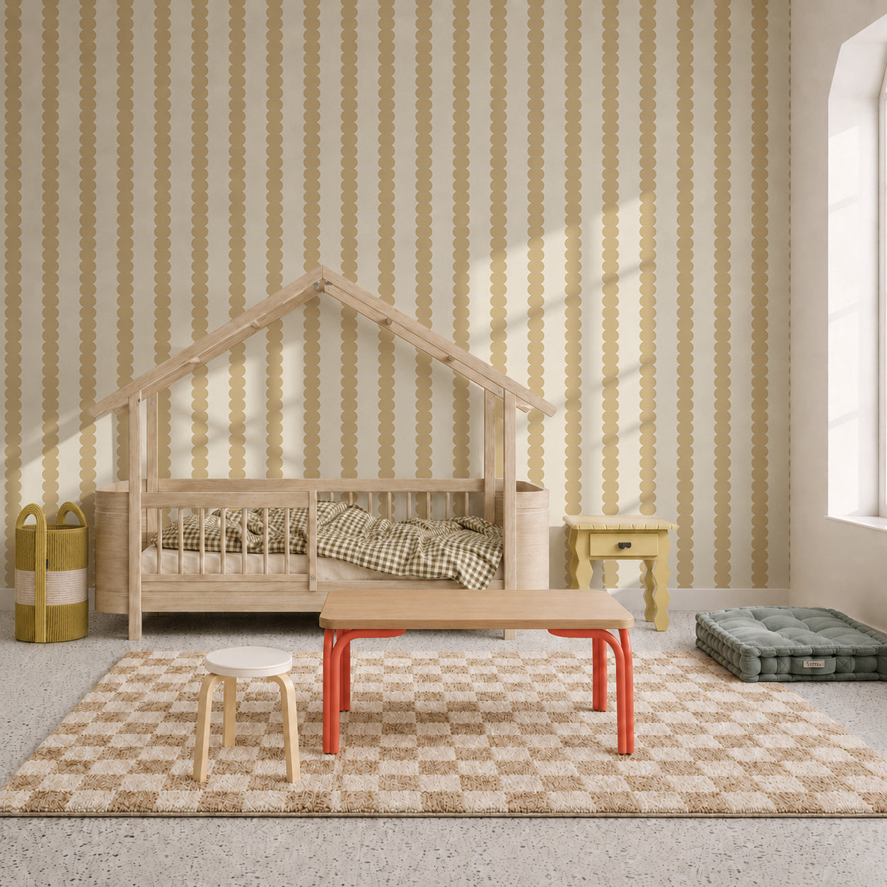 A cozy children’s room features a wooden house-shaped bed, checkered rug, small tables, yellow baskets, and sunlight streaming through a large window. The space is brightened with the Scallop Stripe Wallpaper in Yellow, adding a playful touch and warmth to this inviting nursery.