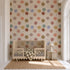 Posy Pop hand-drawn floral wallpaper with oversized colourful flowers on a warm cream background.