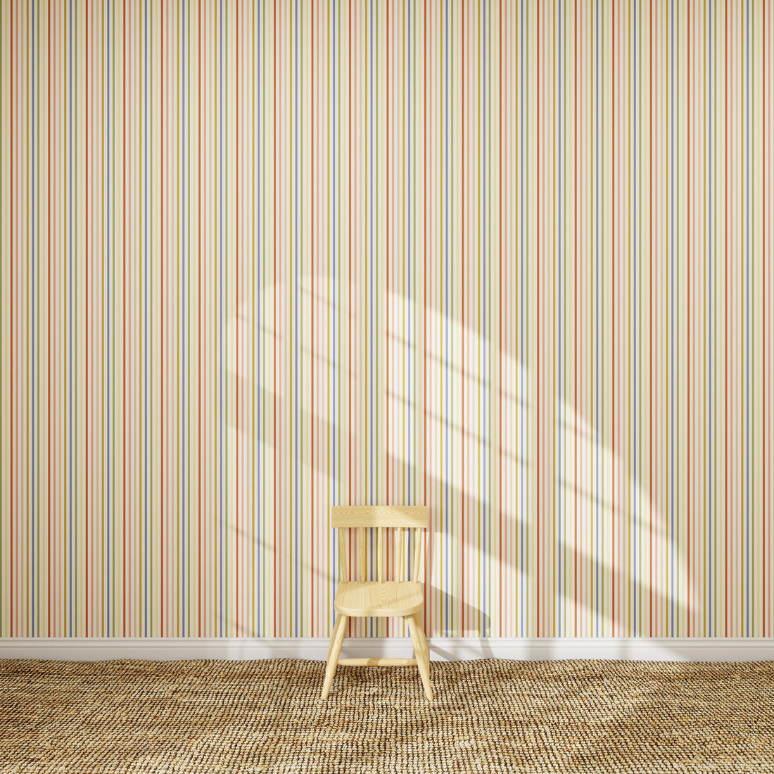 A small wooden chair sits on a woven rug in sunlight, against a wall featuring the Pico Stripe Wallpaper Multi sample with pastel stripes.