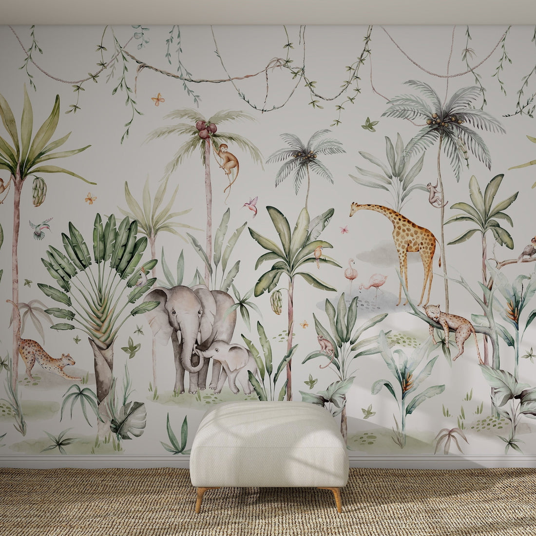 A white wall displays the vibrant Safari Wonderland Mural Sample with jungle animals and tropical plants. A white ottoman rests on a woven rug in front, highlighting the mural’s lively colours and quality.