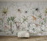 The Safari Wonderland Wallpaper Mural features playful elephants, giraffes, monkeys, and birds among lush green plants in a whimsical watercolor style—ideal for adding charm to any kids&