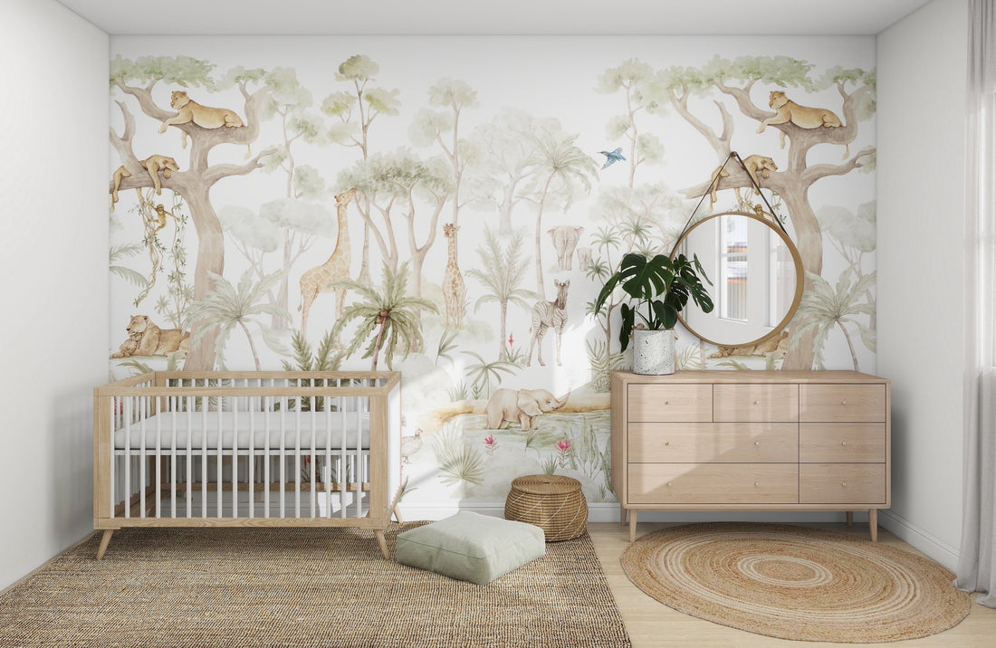 A nursery with a crib and wooden dresser is decorated with the vibrant Safari Savannah Adventure wallpaper from munks and me, showcasing lions, giraffes, and trees. A round mirror above the dresser sits next to a potted plant. On the floor, a woven rug and pouf add coziness.