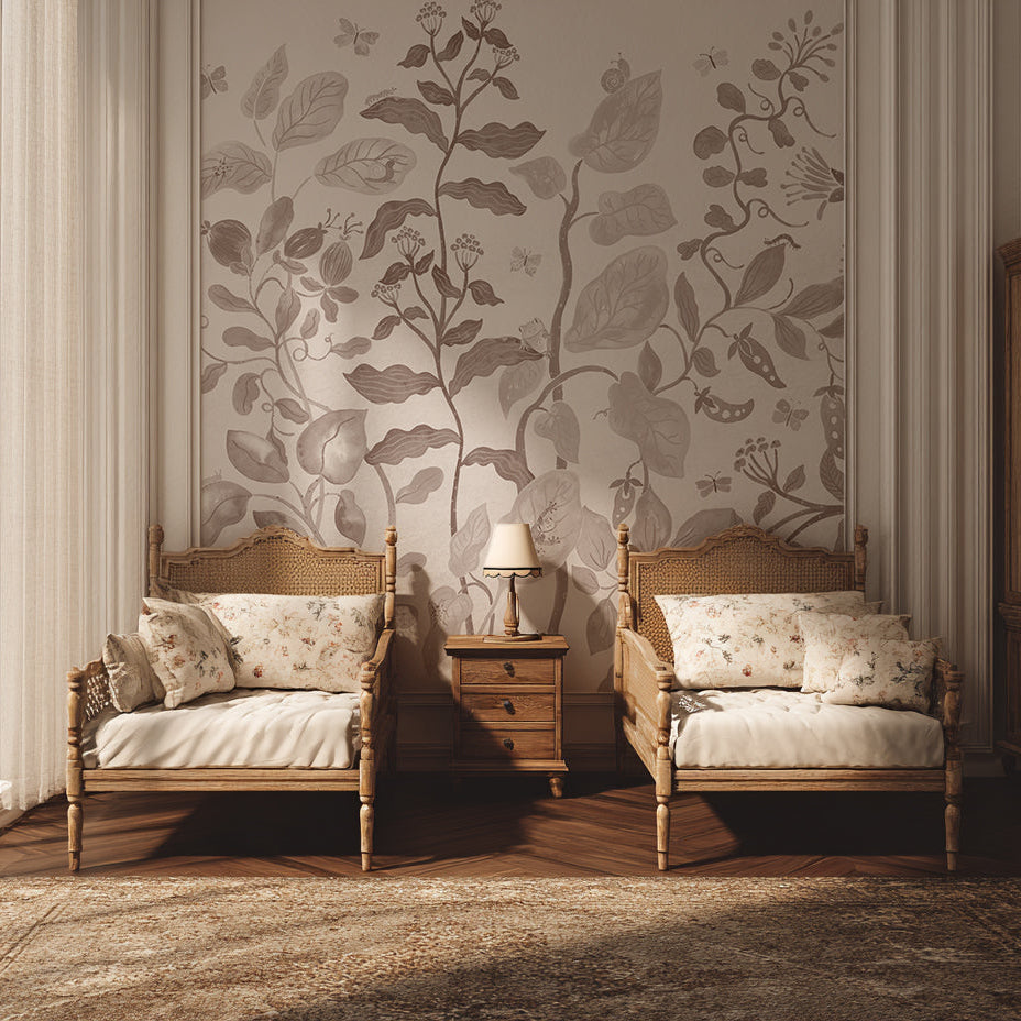 Two vintage-style wooden chairs with cushions flank a small table topped with a lamp, set against a wall covered in Secret Garden Wallpaper Mural Mocha. Soft light spills in through sheer curtains on the left.