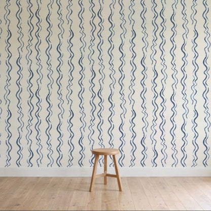 Wallpaper with blue wavy lines on a white background, featuring a wooden stool.