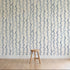 Wallpaper with blue wavy lines on a white background, featuring a wooden stool.