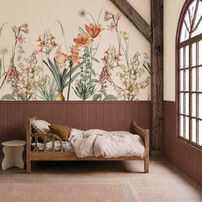 A cozy bedroom with a wooden bed, striped bedding, and the stunning Quinns Flower Field Mural that brings the feel of a lush spring garden to the wall. The room features a large arched window, wood beams, and warm neutral tones.