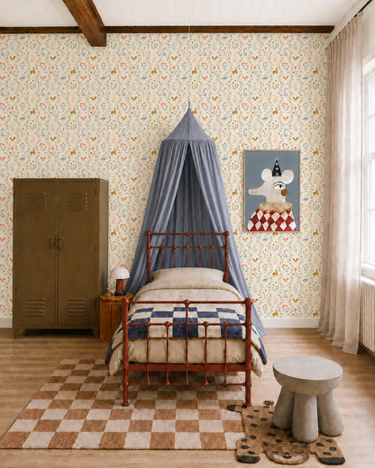 A cozy bedroom with a metal bed, blue canopy, Coles Berry Patch Wallpaper, brown locker, animal artwork, checkered rug, and round table with stools. Sunlight streams through sheer curtains on tall windows.