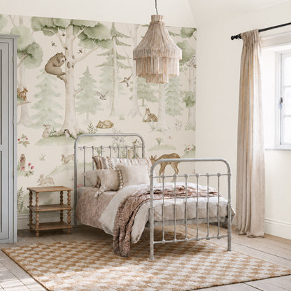 A cozy bedroom featuring a metal bed, neutral bedding, a checkered rug, a wooden side table, and the Woodland Friends Mural adorned with cheerful animals and trees. Light streams in through a window dressed with beige curtains.