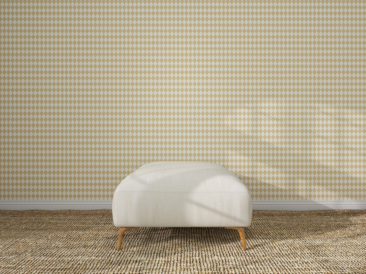 A white upholstered ottoman with wooden legs sits on a textured beige carpet in front of Diamond Dancer Wallpaper, Yellow. Sunlight casts soft shadows across the scene, highlighting the geometric diamond pattern.