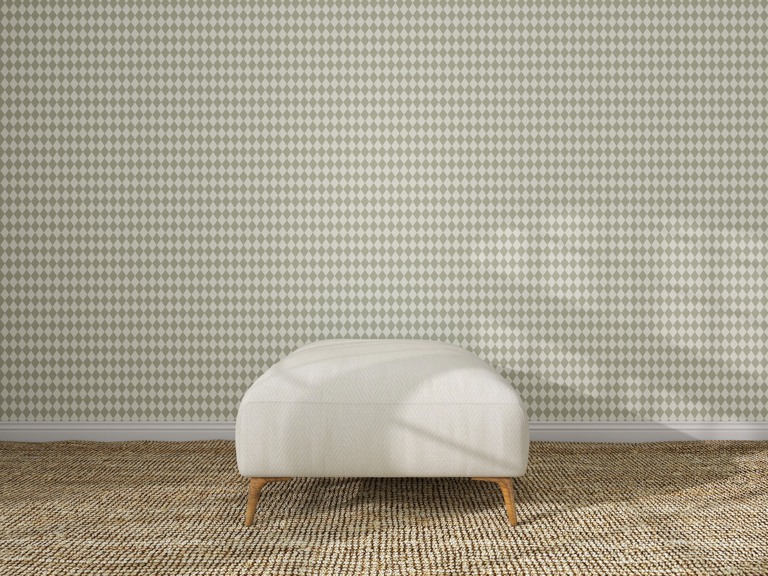 A cream-colored ottoman with wooden legs sits on a woven beige carpet, centered in front of a wall covered with Diamond Dancer Wallpaper, Green.