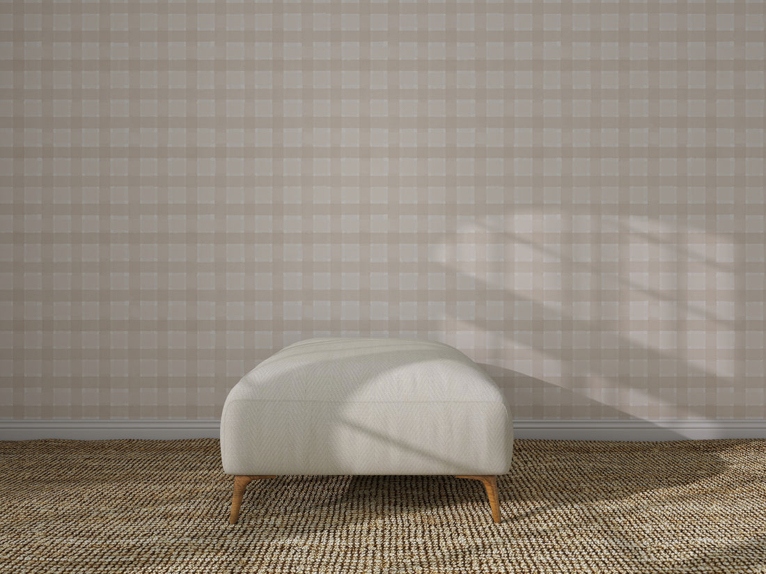 A minimalist interior showcases Checkered Wallpaper, Cream, a light upholstered bench with wooden legs, and a textured woven carpet. Sunlight casts gentle shadows, enhancing the wall decor.