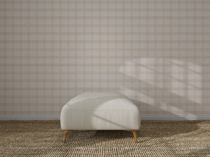 A minimalist interior showcases Checkered Wallpaper, Cream, a light upholstered bench with wooden legs, and a textured woven carpet. Sunlight casts gentle shadows, enhancing the wall decor.