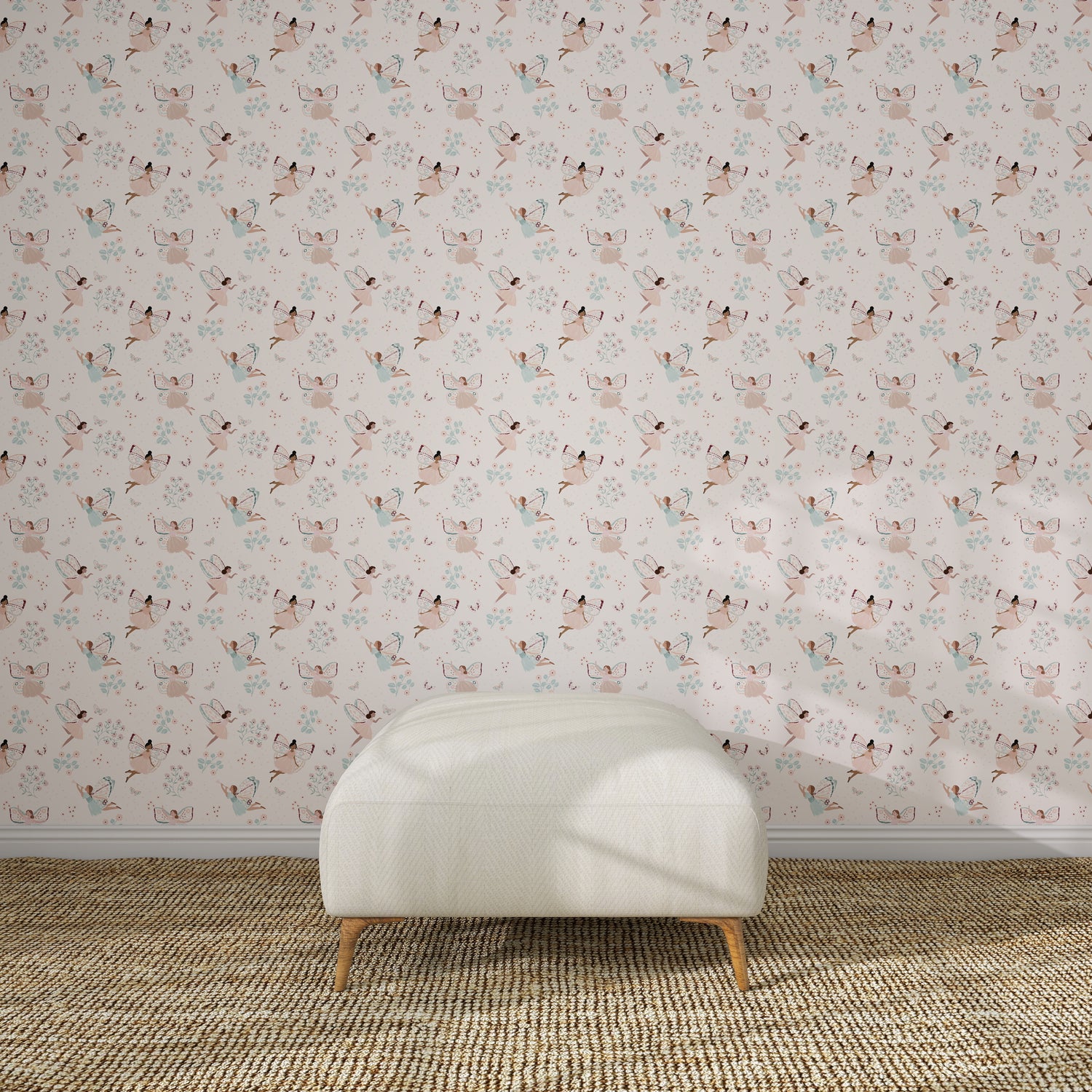 A white upholstered bench on a brown woven rug sits against a light pink wall decorated with Fairy Wonderland Pinks Wallpaper Repeat Pattern, featuring illustrated cats and flowers in a kids&