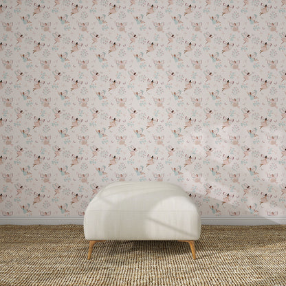 A white upholstered bench on a brown woven rug sits against a light pink wall decorated with Fairy Wonderland Pinks Wallpaper Repeat Pattern, featuring illustrated cats and flowers in a kids&