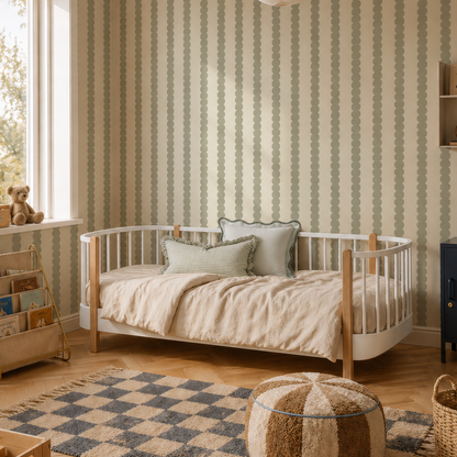 Cozy children’s bedroom featuring a round-edged bed, bookshelf, toys, woven storage baskets, a pouf, checkered rug on wooden floors, warm neutral tones throughout, and Scallop Stripe Wallpaper in Green. Large window lets in plenty of light.