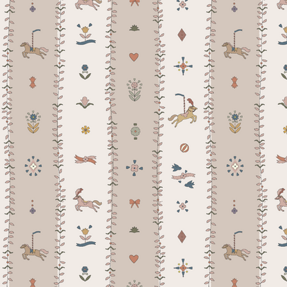 The Little Carousel Stripe Wallpaper, Rose features carousel horses, flowers, hearts, birds, bows, and geometric shapes in soft pastel tones on a cream and beige background—perfect for adding vintage circus charm to a nursery.