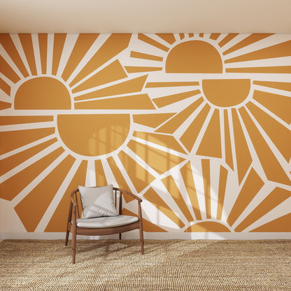 A modern room features the Sunbeams Wallpaper Repeat Pattern with stylized orange and white sunrises, a wooden chair with a gray cushion, and a woven rug. Sunlight enhances the sunshine-inspired decor.