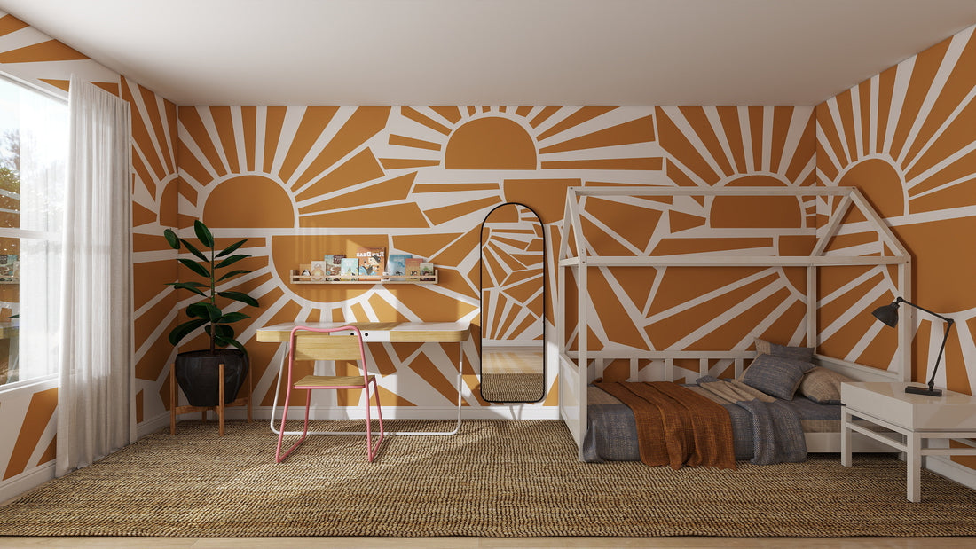 A brightly lit kids’ bedroom features the Sunbeams Wallpaper Repeat Pattern in white and orange, a house-shaped bunk bed, a desk with a pink chair, a floor plant, a wall mirror, and a large window with white curtains.