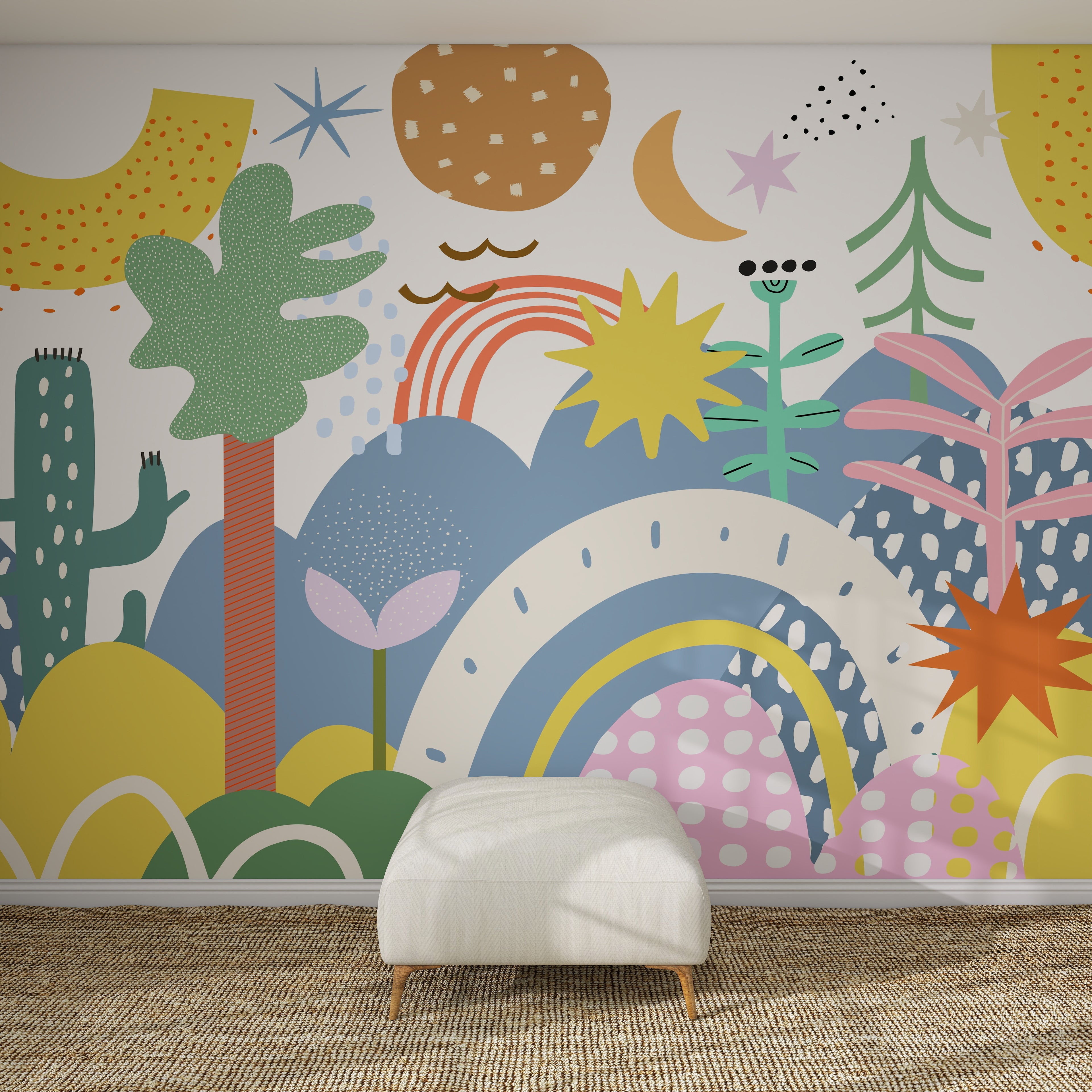 The Happy Wall Wallpaper Mural showcases colorful shapes, plants, stars, rainbows, a crescent moon, and playful patterns on a white wall behind a white ottoman with a woven rug, creating a lively and whimsical atmosphere.