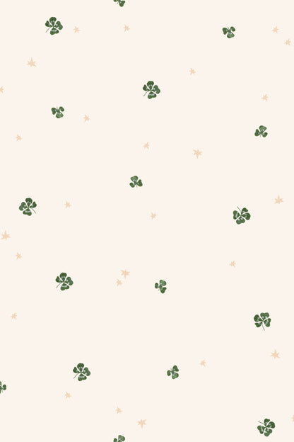 Pattern of small green clover leaves on a beige background