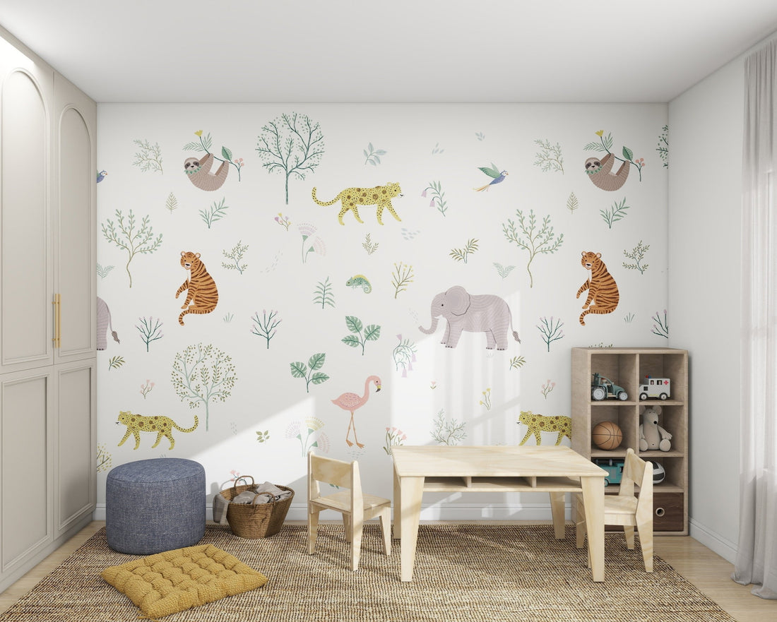 The Wild Wonders Wallpaper Mural by munks and me showcases exotic animals like elephants, tigers, leopards, and sloths in a childrens room. A light wooden table sits on a beige rug, perfectly paired with shelves brimming with toys and books.