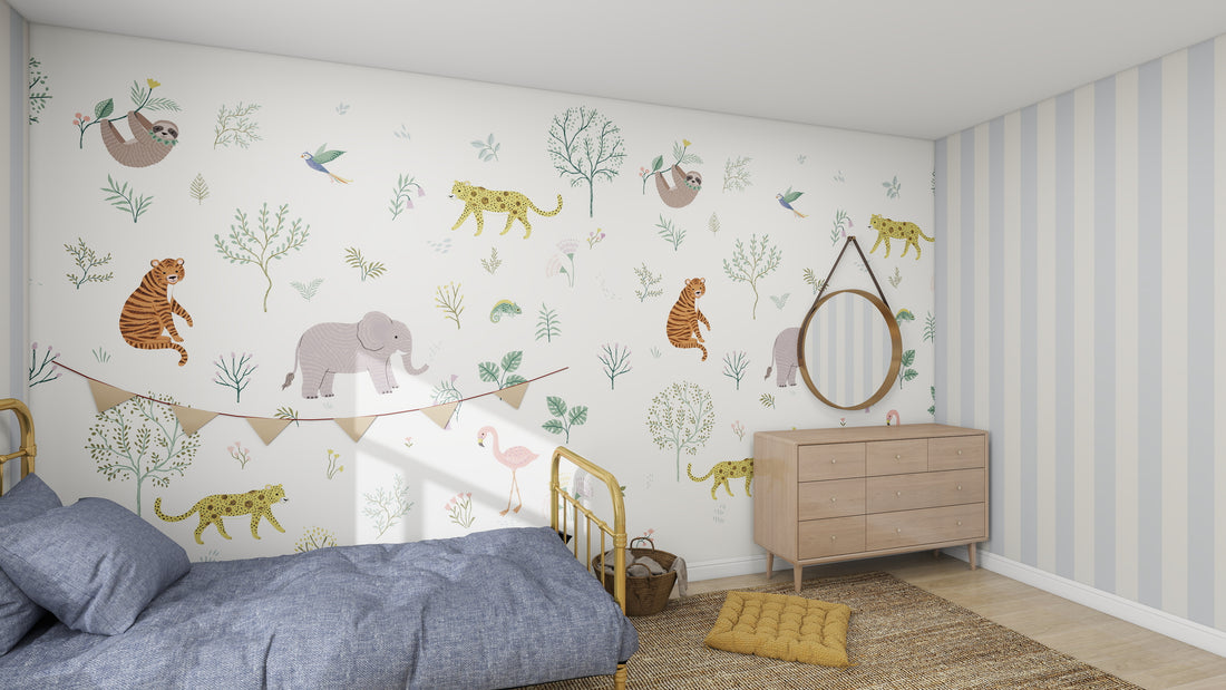 In the childrens bedroom, munks and mes Wild Wonders Wallpaper Mural displays elephants, tigers, and birds in a forest. On the left is a brass bed with blue bedding; on the right is a wooden dresser with a round mirror. The floor includes a woven cushion and small rug.