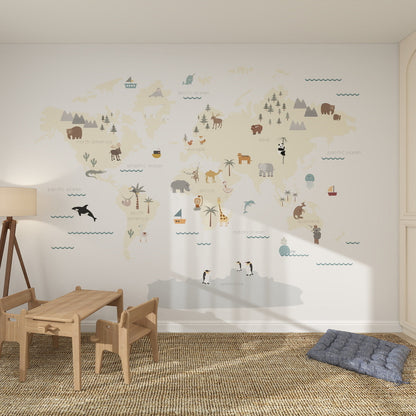 A children’s playroom with a wooden table and chairs, a soft rug, and the Character World Map Wallpaper Mural featuring illustrated animals for fun kids room decor. A blue floor cushion sits in the corner.