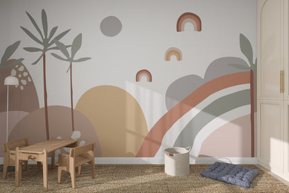 A childrens room with a wooden table and chairs, a basket, and a floor cushion features the Abstract Wren Wallpaper Mural, showcasing rainbows, plants, and shapes in earthy tones on the wall.