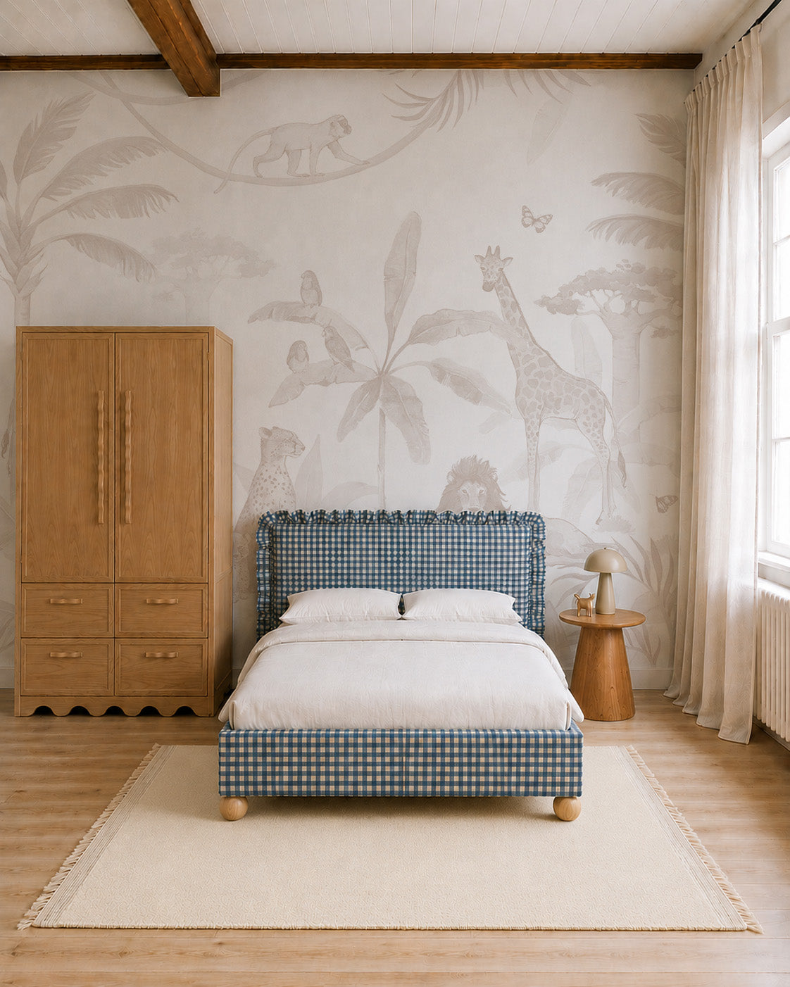 Minimalist bedroom featuring a blue plaid bed, light bedding, wooden wardrobe and side table, large window, and the African Safari Mural, Neutral—a nursery mural showcasing animals and plants in soft neutral tones. Natural light fills the space.