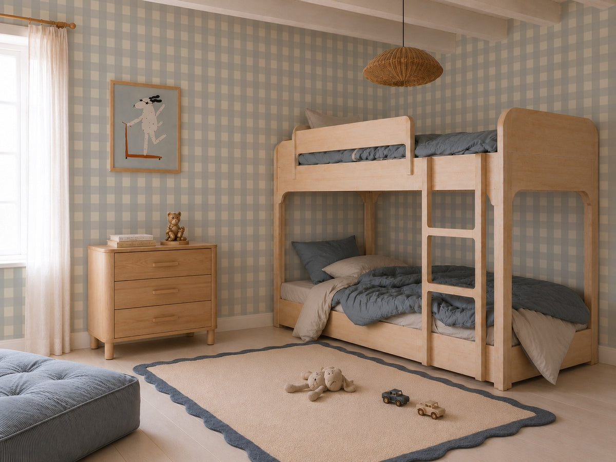 A children’s bedroom featuring a light wood bunk bed, a matching dresser, and Large Check Wallpaper, Blue.