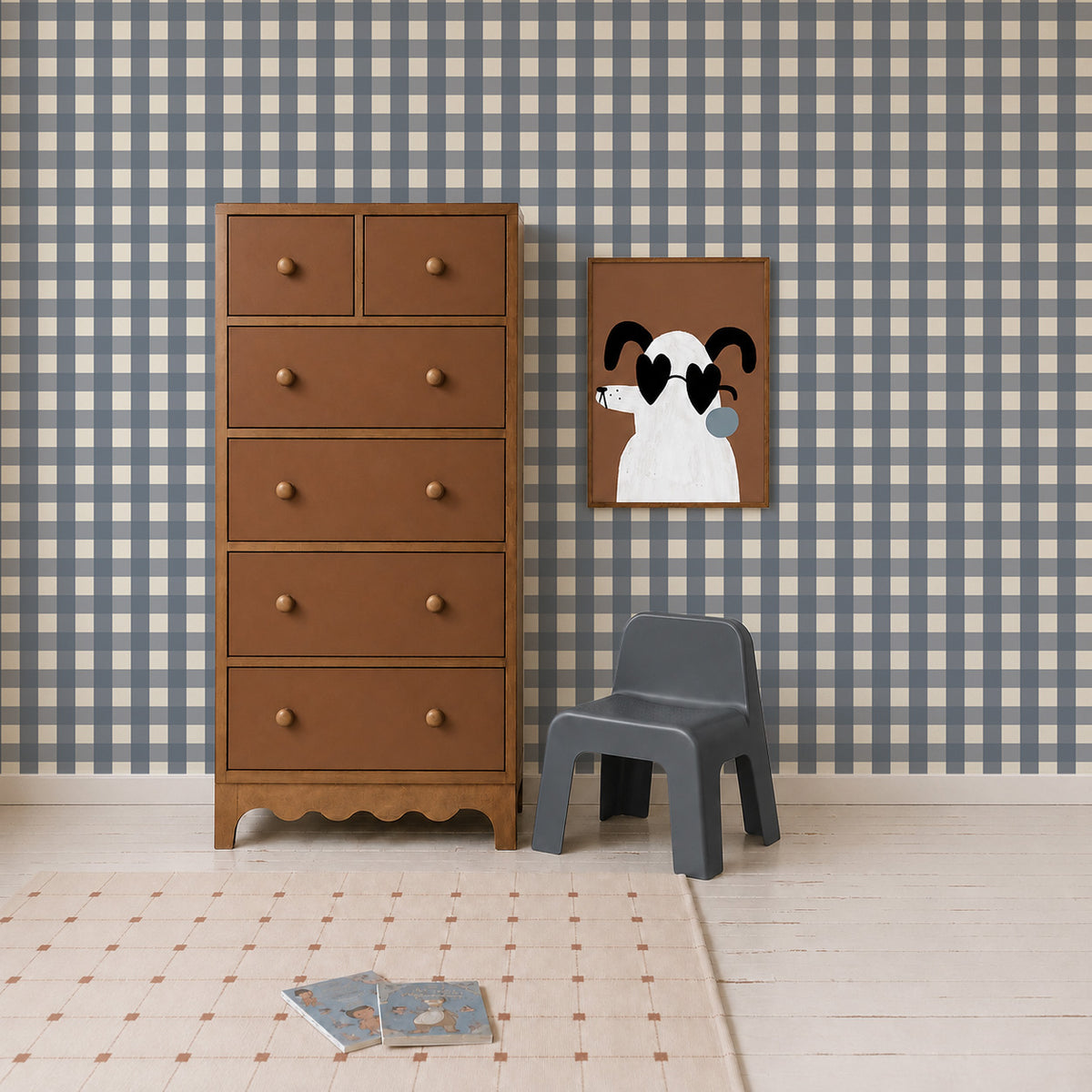 A brown wooden chest of drawers, a grey child’s chair, and a framed print of a dog wearing heart-shaped sunglasses, set against Large Check Wallpaper, Deep Blue.