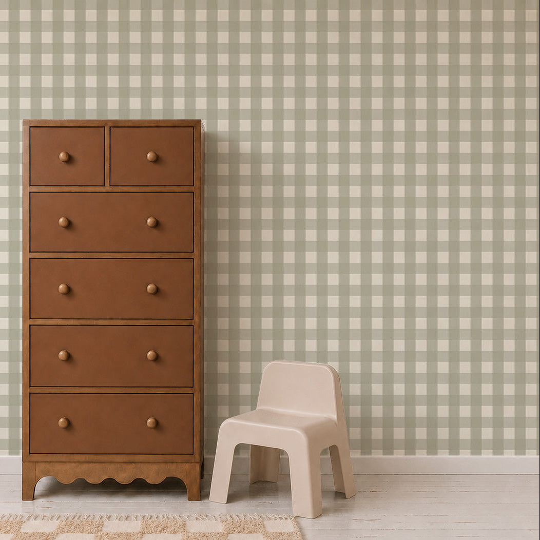 A tall wooden chest of drawers and a small plastic chair against a wall with Large Check Wallpaper, Green.