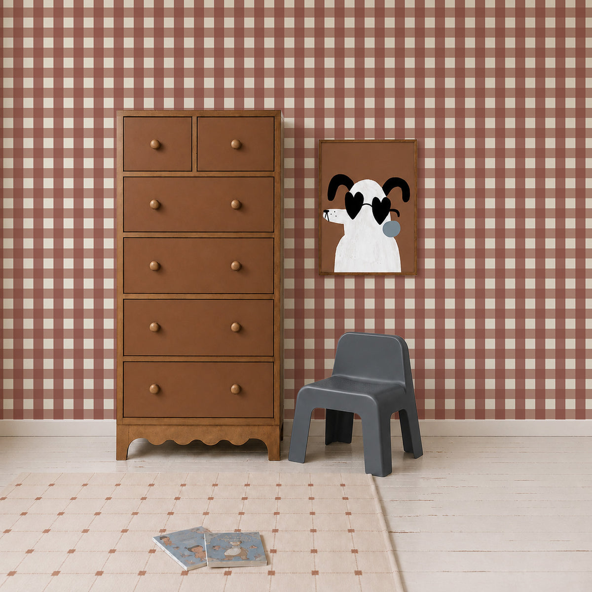 A wooden chest of drawers, a small grey chair, and a framed print of a dog wearing heart-shaped sunglasses, set against Large Check Wallpaper, Red.