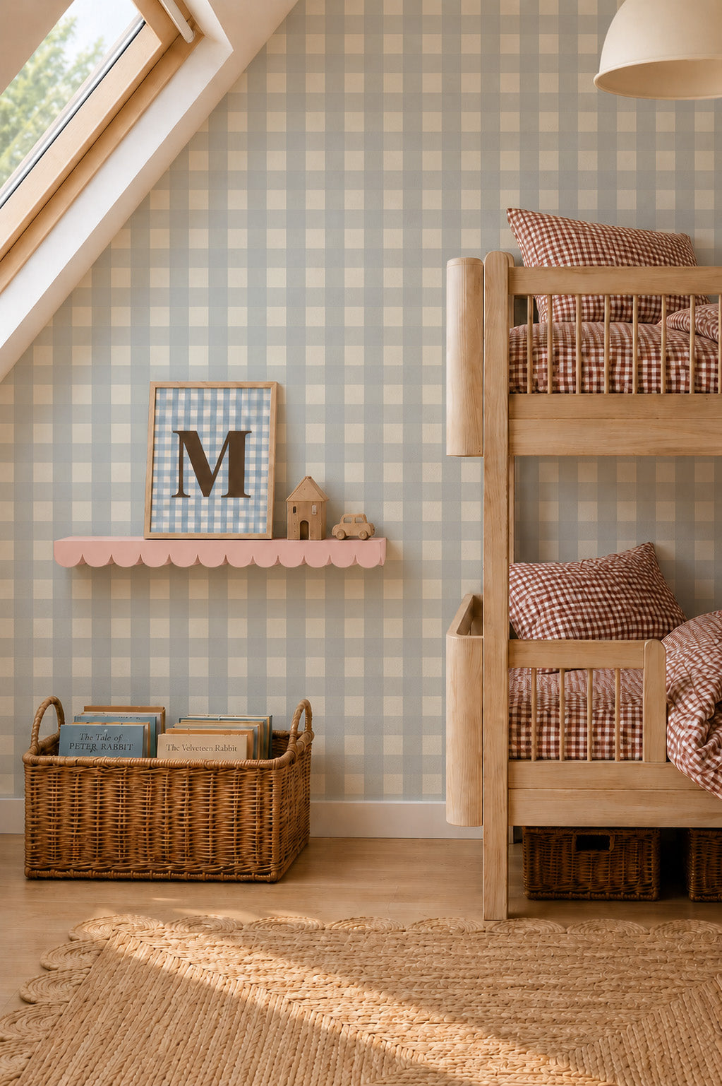 A child’s bedroom featuring a wooden bunk bed, a scalloped shelf holding a framed letter M, and a woven basket filled with books against a backdrop of Large Check Wallpaper Sample, Blue.