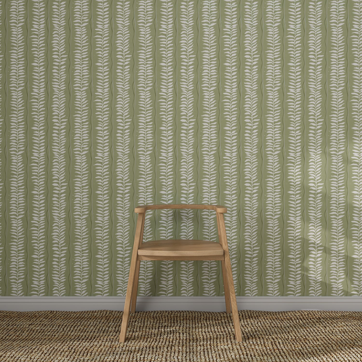 A wooden chair with a simple design sits on a woven rug in front of Meadow Leaf Stripe Wallpaper, Sage, its white botanical stripes adding charm to the cozy space.