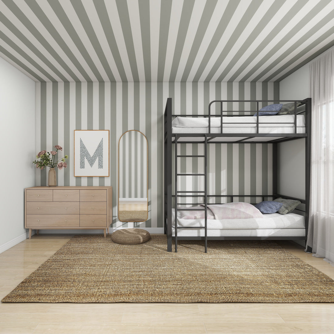 The bedroom features munks and mes Circus Stripe Wallpaper Matcha on the walls and ceiling. A black metal bunk bed with pink and blue bedding takes center stage, perfect for kids. A wooden dresser adorned with flowers and framed art complements the cozy vibe, along with a woven rug on the floor.