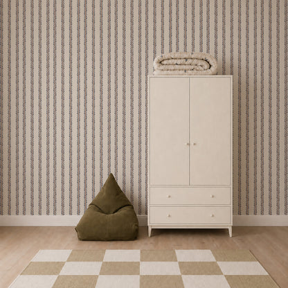 Minimalist room featuring the Folk Scallop Stripe Wallpaper in Chambray &amp; Mocha, a white wardrobe with folded blankets on top, a green bean bag chair, and a beige-checkered rug on a wooden floor.