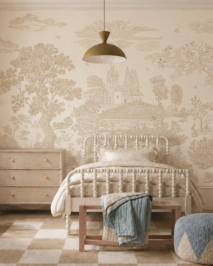 A cozy bedroom with a vintage spindle bed, light bedding, wooden bench with blue throw, three-drawer dresser, and a Forest Hideaway Mural, Neutral depicting trees and a distant castle. A modern pendant light hangs above.