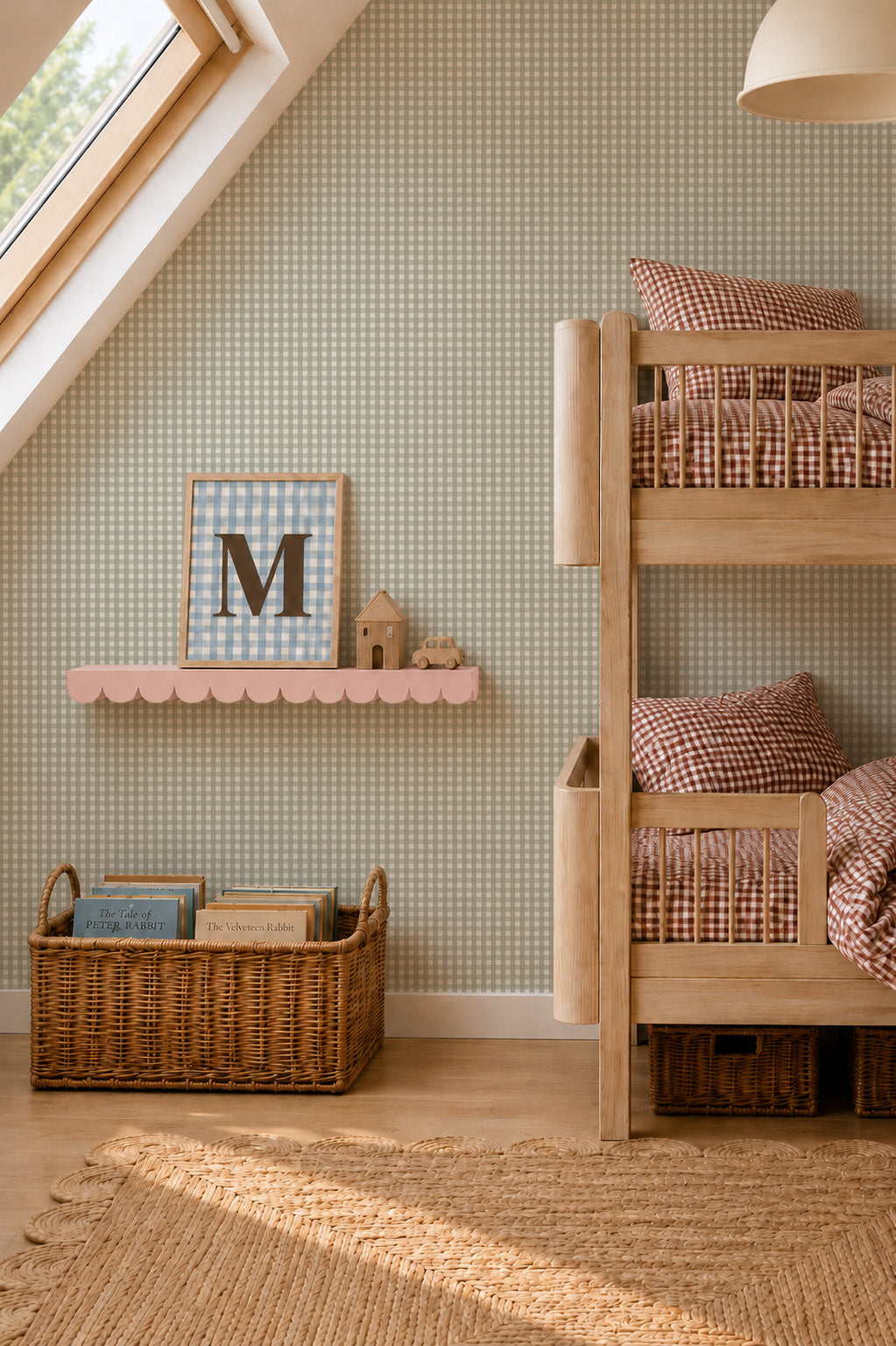 A children’s room with a wooden bunk bed, a scalloped pink wall shelf displaying a framed letter M, and a wicker basket filled with storybooks against Mini Check Wallpaper Sample, Green.